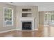Cozy living room with fireplace, large window, and hardwood floors at 211 Oak Landing Dr., Conway, SC 29527