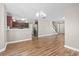 Open living space with hardwood floors, staircase, and partial view of the kitchen at 211 Oak Landing Dr., Conway, SC 29527