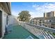 Relaxing balcony with synthetic grass, seating, and beautiful view of the pool at 212 Maison Dr. # M 303, Myrtle Beach, SC 29572