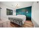 Relaxing bedroom with green accent wall, comfy bed, bedside lamps, and natural light at 212 Maison Dr. # M 303, Myrtle Beach, SC 29572