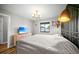 Comfortable bedroom features accent wall, modern lamp, dresser with TV, and window views at 212 Maison Dr. # M 303, Myrtle Beach, SC 29572