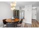 Dining area is illuminated with modern lighting above wooden table with seating for four at 212 Maison Dr. # M 303, Myrtle Beach, SC 29572