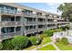 Exterior perspective of a condo building featuring balconies, lush landscaping, and community pool access at 212 Maison Dr. # M 303, Myrtle Beach, SC 29572
