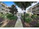Peaceful walkway leading to the enclosed community pool, surrounded by lush greenery at 212 Maison Dr. # M 303, Myrtle Beach, SC 29572