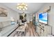Bright and airy living room with stylish furnishings, hardwood floors, and a view into the dining area at 212 Maison Dr. # M 303, Myrtle Beach, SC 29572