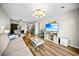 Inviting living room boasts modern furniture, decor, hardwood floors, and great lighting at 212 Maison Dr. # M 303, Myrtle Beach, SC 29572