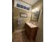 Traditional bathroom featuring patterned wallpaper, a framed mirror, and a neutral vanity at 234 Ave. Of The Palms, Myrtle Beach, SC 29579