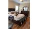 Bedroom with hardwood floors, fan, and large dog on the bed at 234 Ave. Of The Palms, Myrtle Beach, SC 29579
