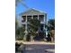 Charming three-story home with columned balconies and grand brick steps leading to a covered entry at 234 Ave. Of The Palms, Myrtle Beach, SC 29579