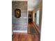 Hallway with hardwood floors, accent wall, and decorative rug at 234 Ave. Of The Palms, Myrtle Beach, SC 29579