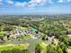 Aerial view of a beautiful neighborhood with lush greenery, a pond, and a golf course in the background at 25 Bentley Ct., Pawleys Island, SC 29585