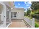 Spacious back deck with view of lush backyard, screened-in porch, and slider at 25 Bentley Ct., Pawleys Island, SC 29585