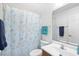 Bathroom with floral shower curtain, light blue hand towels, and bright lighting at 25 Bentley Ct., Pawleys Island, SC 29585