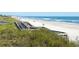 Beautiful beach with a sandy shore, blue ocean, and wooden walkway access at 25 Bentley Ct., Pawleys Island, SC 29585
