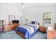 Bedroom with vaulted ceiling, ceiling fan, large windows, and classic wood furniture at 25 Bentley Ct., Pawleys Island, SC 29585