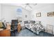 Comfortable bedroom featuring ceiling fan, large window, and desk for workspace at 25 Bentley Ct., Pawleys Island, SC 29585