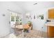 Cozy dining area with round table, four chairs, and access to the patio via sliding glass door at 25 Bentley Ct., Pawleys Island, SC 29585