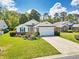 Charming single-story home featuring a well-manicured lawn and an attached garage with an inviting driveway at 25 Bentley Ct., Pawleys Island, SC 29585