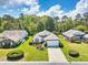 Inviting single-story house with a manicured lawn, vibrant flower beds, and a cozy curb appeal at 25 Bentley Ct., Pawleys Island, SC 29585