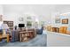 Open living room boasts vaulted ceilings, natural light, and seamless flow to the dining area at 25 Bentley Ct., Pawleys Island, SC 29585
