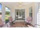 Cozy screened-in porch with ceiling fan, tile floor, and relaxing seating at 25 Bentley Ct., Pawleys Island, SC 29585