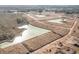 Expansive aerial view of land development featuring ponds, construction equipment, and planned residential areas, showcasing community growth at 2824 Riverboat Way, Conway, SC 29526
