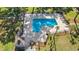 Aerial view of the community pool with lounge chairs, lush landscaping, and secure fencing at 3015 Old Bryan Dr. # 9-7, Myrtle Beach, SC 29577