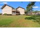 Exterior angle shows a grassy backyard and decks of condo building at 3015 Old Bryan Dr. # 9-7, Myrtle Beach, SC 29577