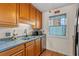 Traditional kitchen featuring wood cabinets, stainless steel appliances, and window with a blue and yellow sunflower valance at 3015 Old Bryan Dr. # 9-7, Myrtle Beach, SC 29577