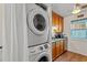 Convenient laundry space features a stacked washer/dryer next to the kitchen at 3015 Old Bryan Dr. # 9-7, Myrtle Beach, SC 29577