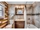 Nicely tiled bathroom with a shower/tub combo, decorative mirror, and efficient use of space at 329 46Th Ave. N, North Myrtle Beach, SC 29582