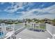 Deck overlooking a serene waterfront, furnished with white patio furniture, set against a beautiful sunny sky at 329 46Th Ave. N, North Myrtle Beach, SC 29582