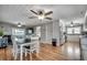 Open dining area with hardwood floors, white chairs, and adjacent kitchen and living spaces at 329 46Th Ave. N, North Myrtle Beach, SC 29582
