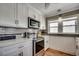 This kitchen features stainless steel appliances, white cabinets and a microwave at 329 46Th Ave. N, North Myrtle Beach, SC 29582