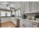 Bright kitchen features white cabinets, stainless steel appliances, wood floors, and ample natural light at 329 46Th Ave. N, North Myrtle Beach, SC 29582
