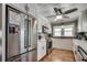 Updated kitchen showcases stainless steel refrigerator and appliances, white cabinets, and wood flooring at 329 46Th Ave. N, North Myrtle Beach, SC 29582