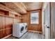 Functional laundry room featuring modern washer and dryer units, wood paneling, and ample shelving at 329 46Th Ave. N, North Myrtle Beach, SC 29582