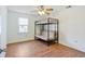 Bedroom with a wooden floor, a window with blinds and a bunk bed with a futon at 349 Robin Hood Circle, Little River, SC 29566