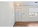 Foyer featuring wood-look floors, chandelier, white door with glass insert and adjacent window at 349 Robin Hood Circle, Little River, SC 29566