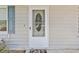 Close up of the front door with white trim and blue shutters at 349 Robin Hood Circle, Little River, SC 29566