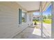 View of a cozy front porch showing white columns, blue shutters, and pea gravel landscaping at 349 Robin Hood Circle, Little River, SC 29566