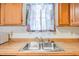Double basin sink with chrome faucet set in a kitchen with light wood cabinets at 349 Robin Hood Circle, Little River, SC 29566