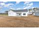 Spacious backyard featuring a newly built home with white siding and a concrete patio at 364 Hayloft Circle, Conway, SC 29526