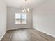 Bright dining room features hardwood floors, chandelier and double window at 364 Hayloft Circle, Conway, SC 29526
