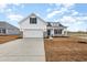 Charming two-story home featuring a 2-car garage, blue accents, and a welcoming front porch at 364 Hayloft Circle, Conway, SC 29526