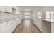 Modern kitchen boasts white cabinets, granite countertops, and stainless steel appliances at 364 Hayloft Circle, Conway, SC 29526