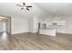 Bright living room with vaulted ceiling flows into a modern kitchen with white cabinets and granite countertops at 364 Hayloft Circle, Conway, SC 29526