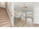 Open-concept living space with hardwood floors, a ceiling fan, stairs, and a view of the kitchen at 364 Hayloft Circle, Conway, SC 29526