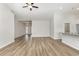 Spacious living room features hardwood floors, a ceiling fan, and an open layout at 364 Hayloft Circle, Conway, SC 29526
