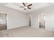 Expansive main bedroom with tray ceiling, neutral walls, and carpet, offering a calming retreat with ensuite access at 364 Hayloft Circle, Conway, SC 29526